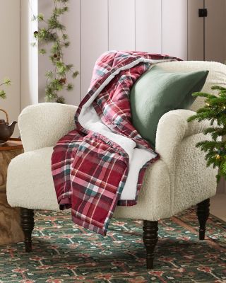 An armchair with a soft plaid throw. Shop blankets & throws.