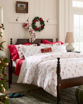 A bed with holiday flannel bedding. Shop bedding.