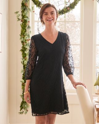 A woman in a black V-Neck Lace Dress. Shop Holiday Looks.